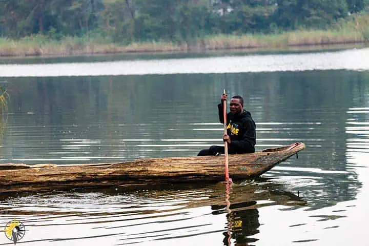 local man canoing on lake bunyonyi